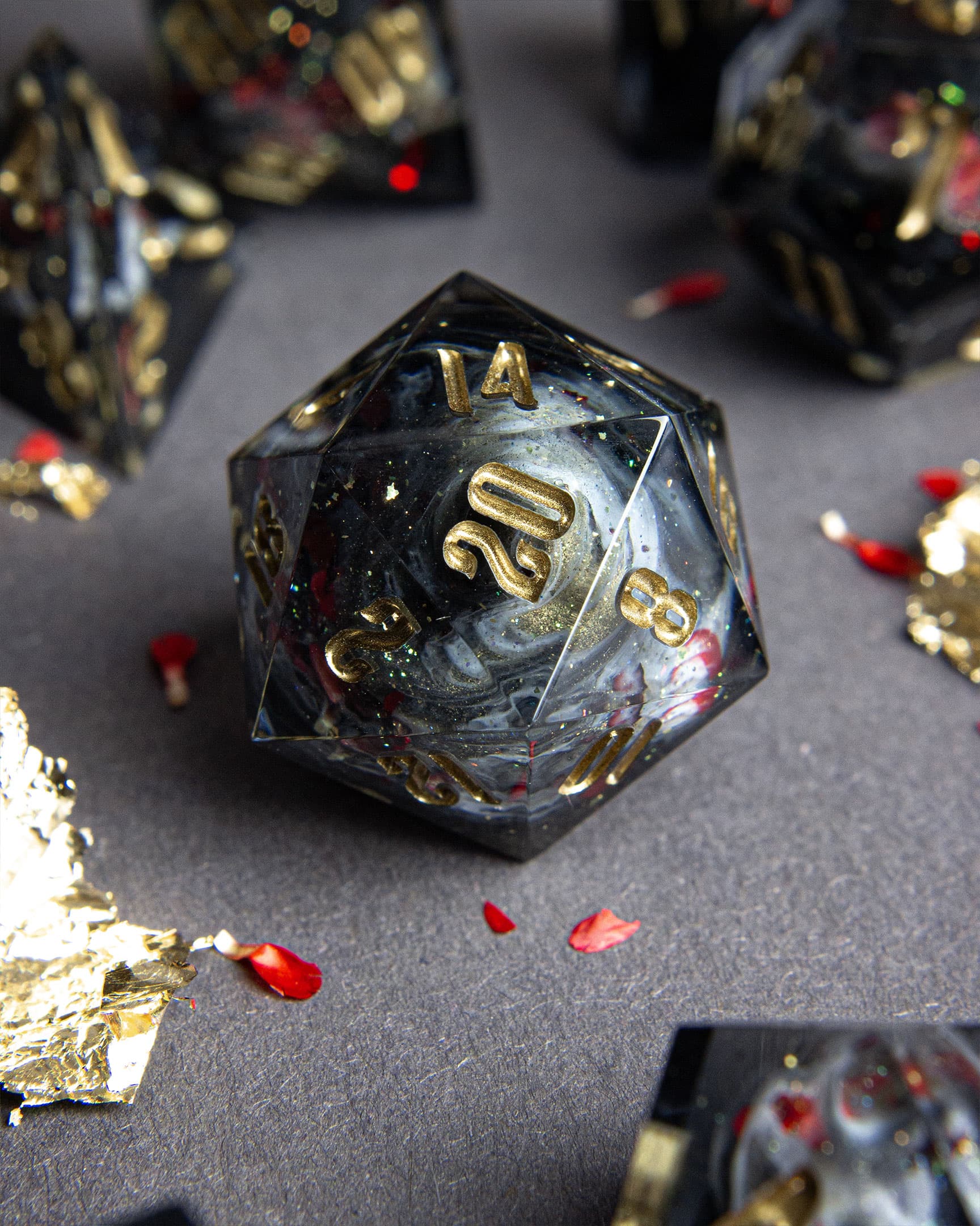 The Last Gommage d20, deep black resin with gold flakes and copper leaf