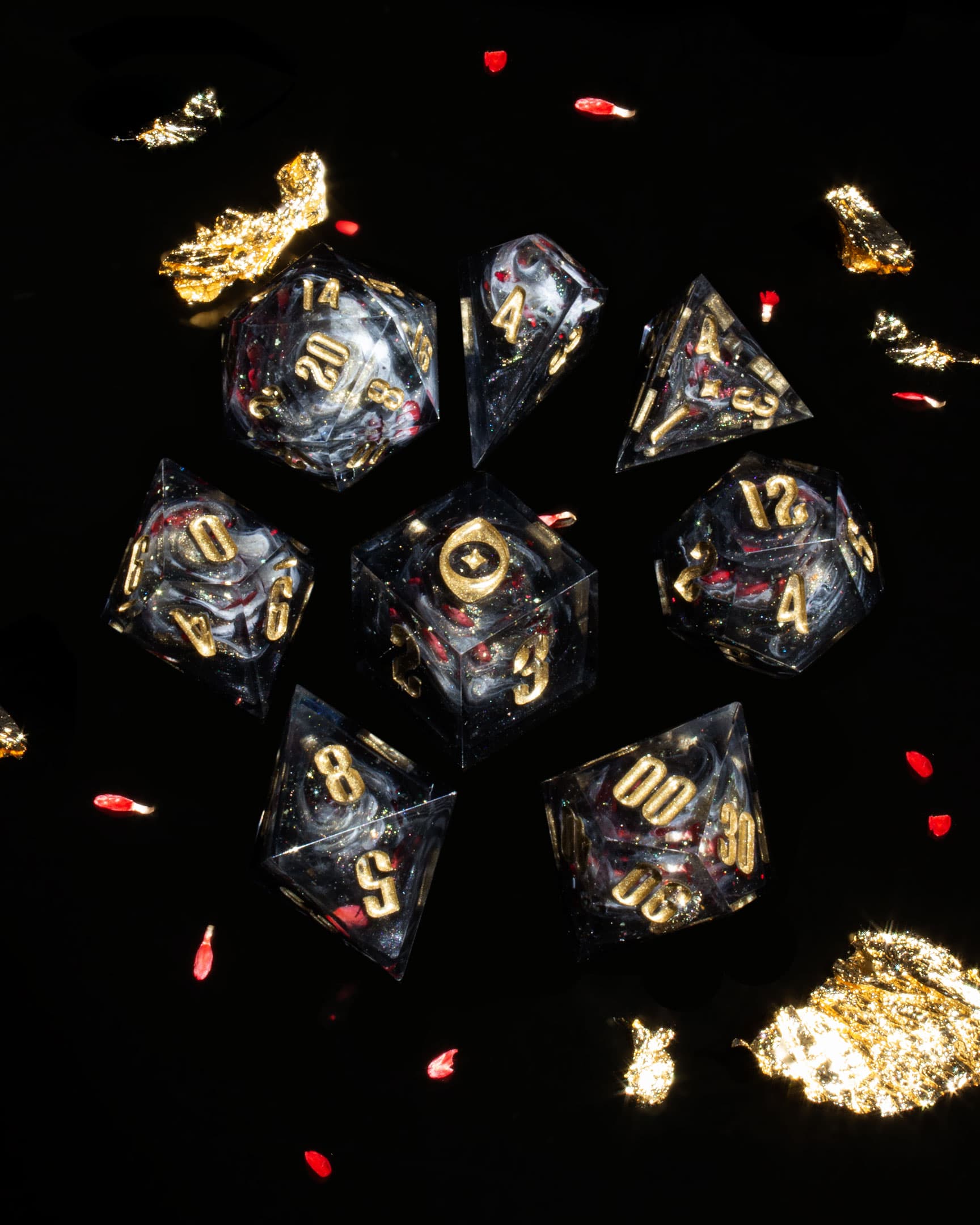 The Last Gommage, full set of 7 arranged on black with gold leaf and rose petals